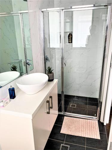 a bathroom with a sink and a shower at Revesby New Self Contained Granny Flat in Revesby