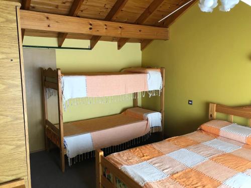 two bunk beds in a room with green walls at Brisas de Mar in Monte Hermoso