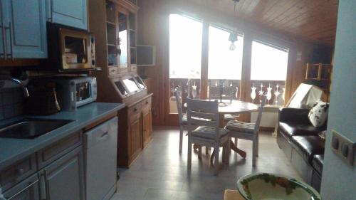 a kitchen with a table and a dining room at St Gervais, Home With A View; 3 Beds, Pkg, Central in Saint-Gervais-les-Bains