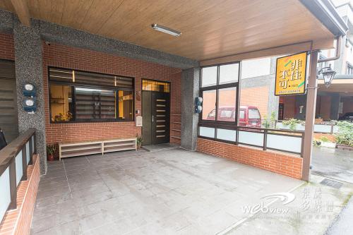 a front door of a brick building with a restaurant at FDBK Homestay in Dongshan