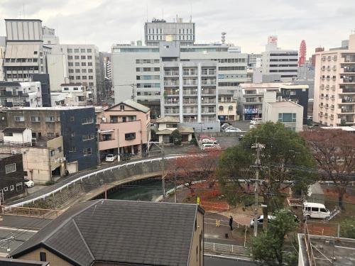 a view of a city with a bridge and buildings at Restay Kokura (Adult Only) in Kitakyushu