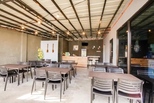 a restaurant with tables and chairs and a counter at The Pocket Hotel in Mactan