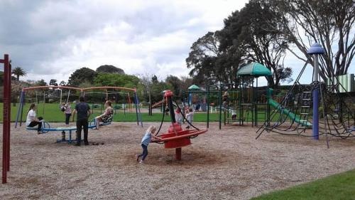 a group of people playing in a playground at The Park Motel in Hawera
