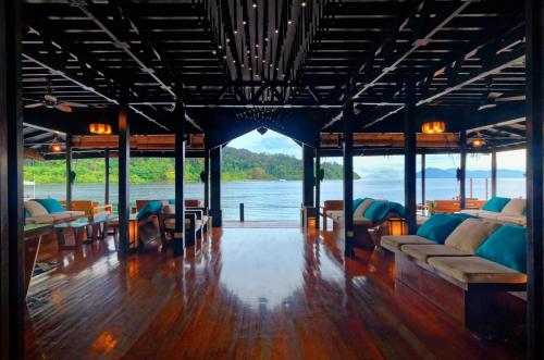 a living room with a view of the water at Gayana Marine Resort in Gaya Island