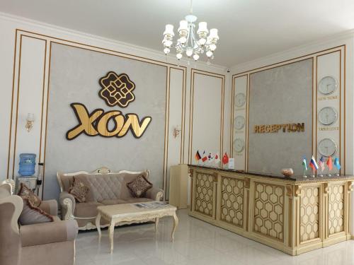 a living room with a couch and a table at Reikartz Xon Tashkent in Tashkent