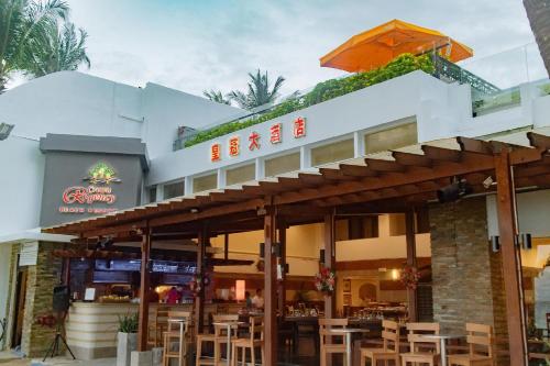 a restaurant with tables and chairs in front of it at Crown Regency Beach Resort in Boracay