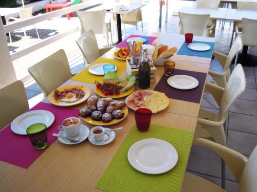 a long table with plates of food on it at Vistamare in Alliste