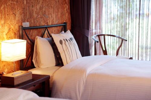 Ein Bett oder Betten in einem Zimmer der Unterkunft 藏青谷 莊園Valley Statt Manor