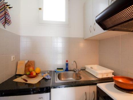 a kitchen with a sink and a counter top at Το Κατἑ in Artemonas