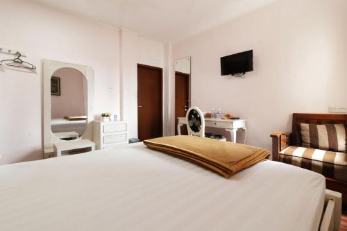 Ένα ή περισσότερα κρεβάτια σε δωμάτιο στο Jayagiri Guesthouse