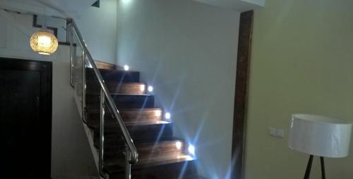 a staircase with a light and a lamp and a lamp at SAHA NOFY Ambohimalaza Guest in Antananarivo