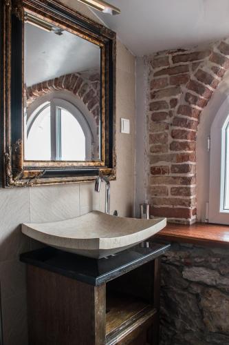 a bathroom with a stone sink and a mirror at Villa Domina in Split