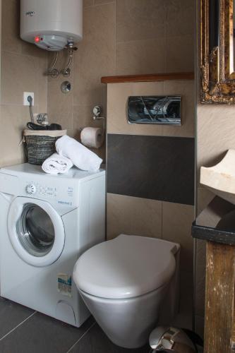 a bathroom with a washing machine and a toilet at Villa Domina in Split