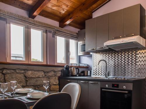 a kitchen with a table with chairs and a sink at Villa Domina in Split