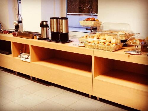 a kitchen counter with some bread and baskets of food at Hotel Europa in Vila Pouca de Aguiar