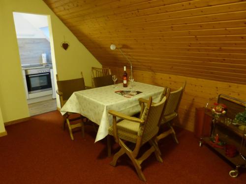 a dining room with a table and chairs and a window at Haus Wald-Eck in Schmallenberg