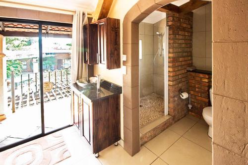 a bathroom with a shower and a toilet in it at Stephan's Guest House in Port Shepstone