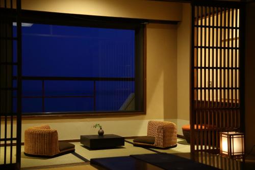 a room with two chairs and a large window at Awakan in Sumoto