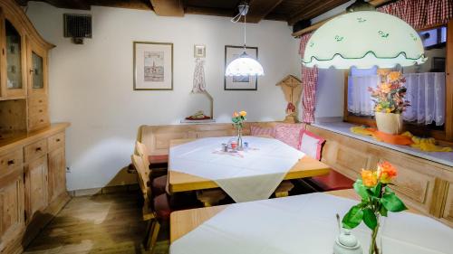 a dining room with a white table and chairs at Restaurant-Café-Pension Himmel in Landshut