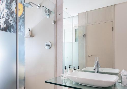 a bathroom with a sink and a mirror at Oude Werf Hotel in Stellenbosch