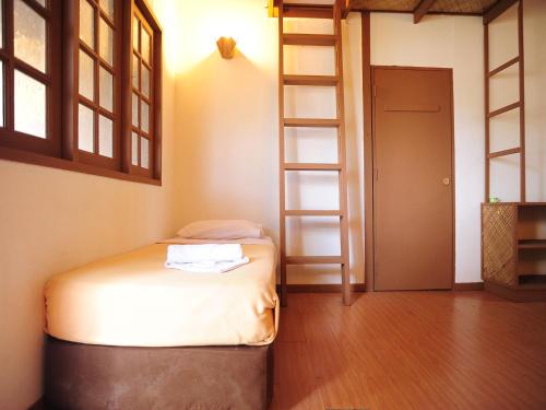 a bedroom with a bunk bed and a ladder at Redang Paradise Resort in Redang Island