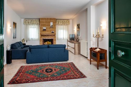 a living room with a blue couch and a fireplace at Villa Eva in Crispiano