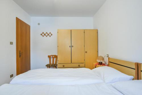 Appartamento Fraine tesisinde bir odada yatak veya yataklar