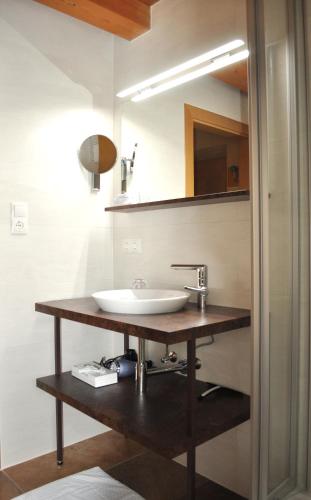 a bathroom with a sink and a mirror at Gasthof Schopper in Breitenbach am Inn