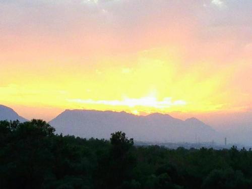 a sunset with a mountain in the background at RiX Studio Park Famagusta Contactless Check In & Check Out in Mağusa