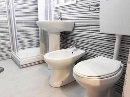 a bathroom with a toilet and a sink at Casa Gentile Caruso in Torrenova