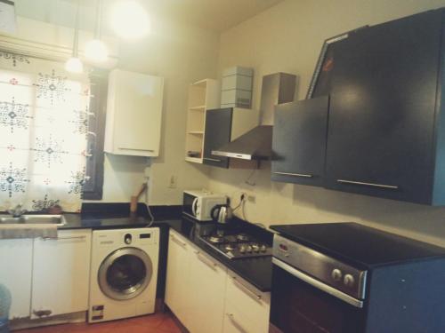 a kitchen with a stove and a washing machine at Villa Private pool cancun El Ain El Sokhna 63 in Ain Sokhna