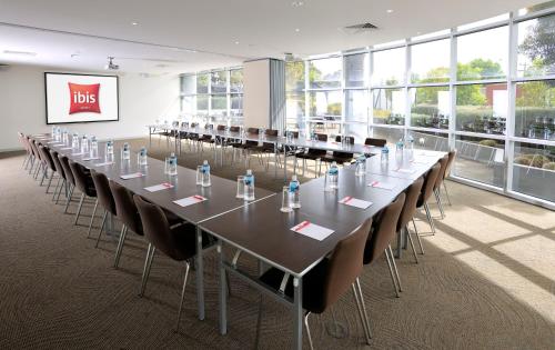a large conference room with a long table and chairs at ibis Melbourne - Glen Waverley in Glen Waverley