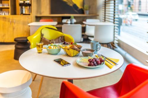 a table with a plate of food on it at ibis Hotel Hamburg St. Pauli Messe in Hamburg