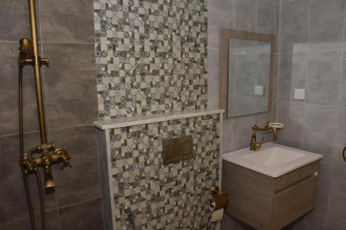 a bathroom with a sink and a mirror at Arabesque Style - 2 appartements in Kelibia