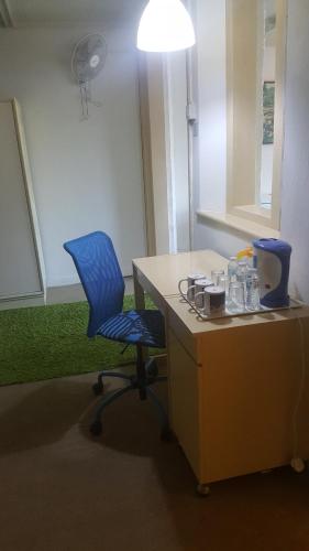 an office with a blue chair and a desk at Bellevue The Penang Hill Hotel, Bukit Bendera in Ayer Itam