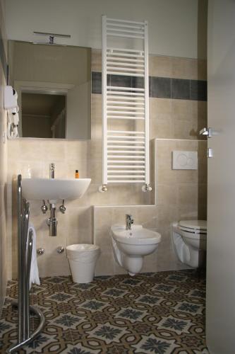 a bathroom with a sink and a toilet at LA DAMA ROOM&BREAKFAST in Russi