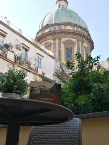 a table in front of a building with a dome at Chiaia Suites in Naples