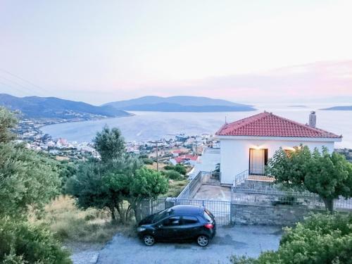 a car parked in front of a white house at Marmari View in Marmarion