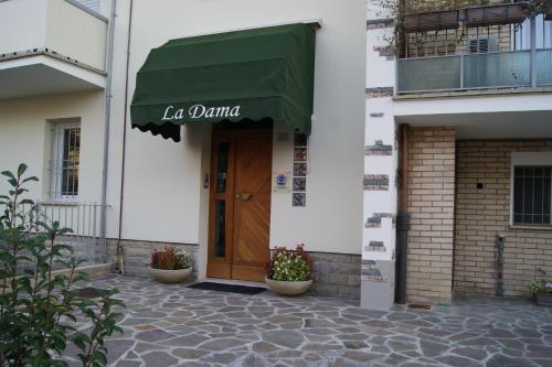 a building with a green awning and a door at LA DAMA ROOM&BREAKFAST in Russi