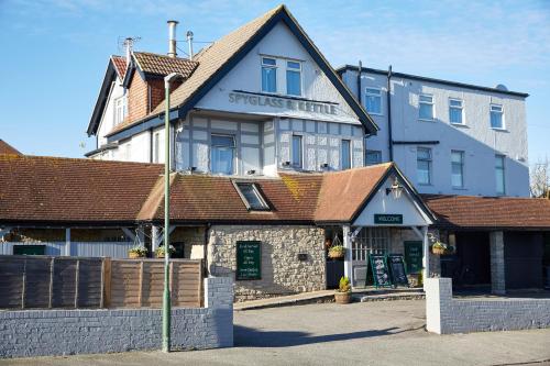 a building with a sign on the front of it at The Spyglass & Kettle by Greene King Inns in Bournemouth