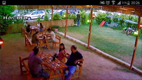 a group of people sitting at tables at a restaurant at Grand Yayla Hotel in Cesme