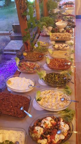 a buffet with many plates of food on a table at Grand Yayla Hotel in Cesme