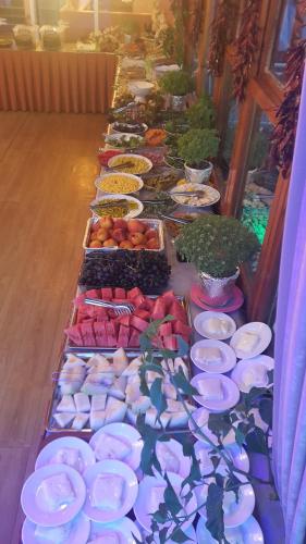 a buffet line with plates and bowls of food at Grand Yayla Hotel in Cesme