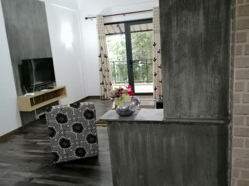 a living room with a chair and a television at Bobato building in Curepipe