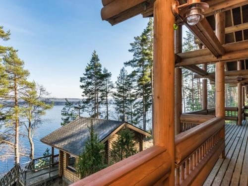a cabin with a view of the water from a window at Holiday Home Roopenranta by Interhome in Asikkala