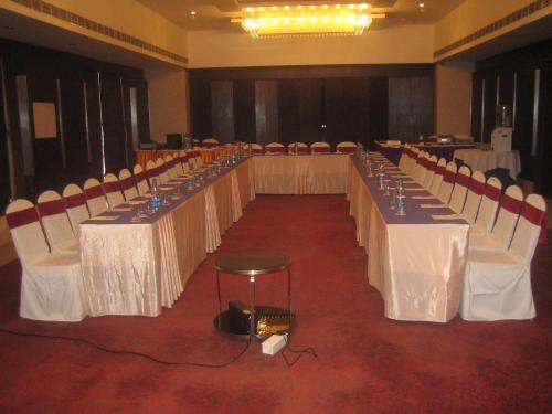 a row of tables and chairs in a banquet hall at Royal Park Kakinada in Kākināda