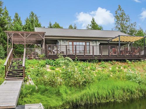 a house with a dock next to a river at Holiday Home Ruuhikari by Interhome in Ulvila