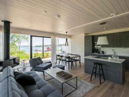 a living room with a couch and a kitchen at Holiday Home Kasnäs marina b 16 by Interhome in Kasnäs