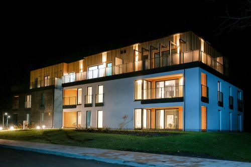 a building is lit up at night at Enklawa Białowieska Forest & Spa in Hajnówka