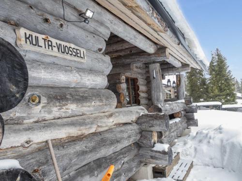 a log cabin in the snow with a sign on it at Holiday Home Kulta-vuosseli a by Interhome in Ruka